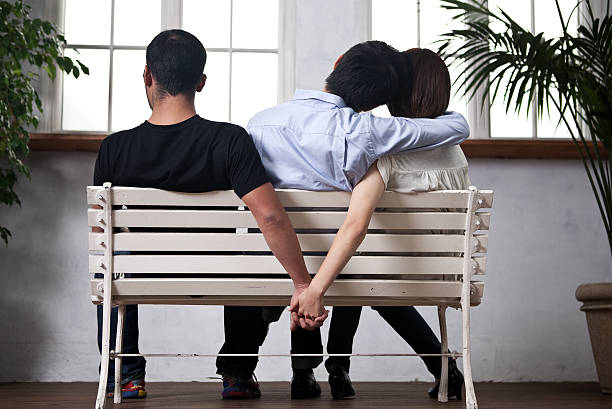 Young woman and man holding their hands behind the seat